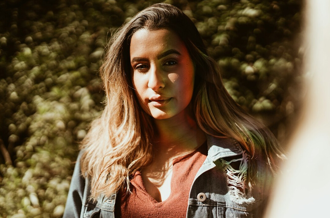Portrait of a young woman with long hair smiling